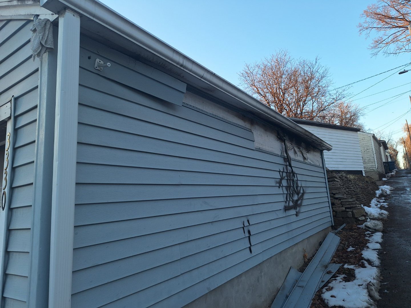 Exterior siding and gutter area inspected for storm damage in Minneapolis, Minnesota